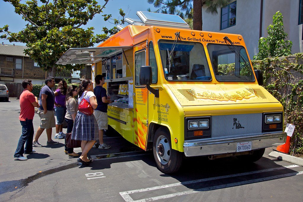 Food truck business serving customers at a mobile restaurant location