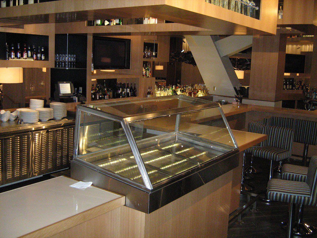 Commercial reach-in refrigerator display case in a professional restaurant setting
